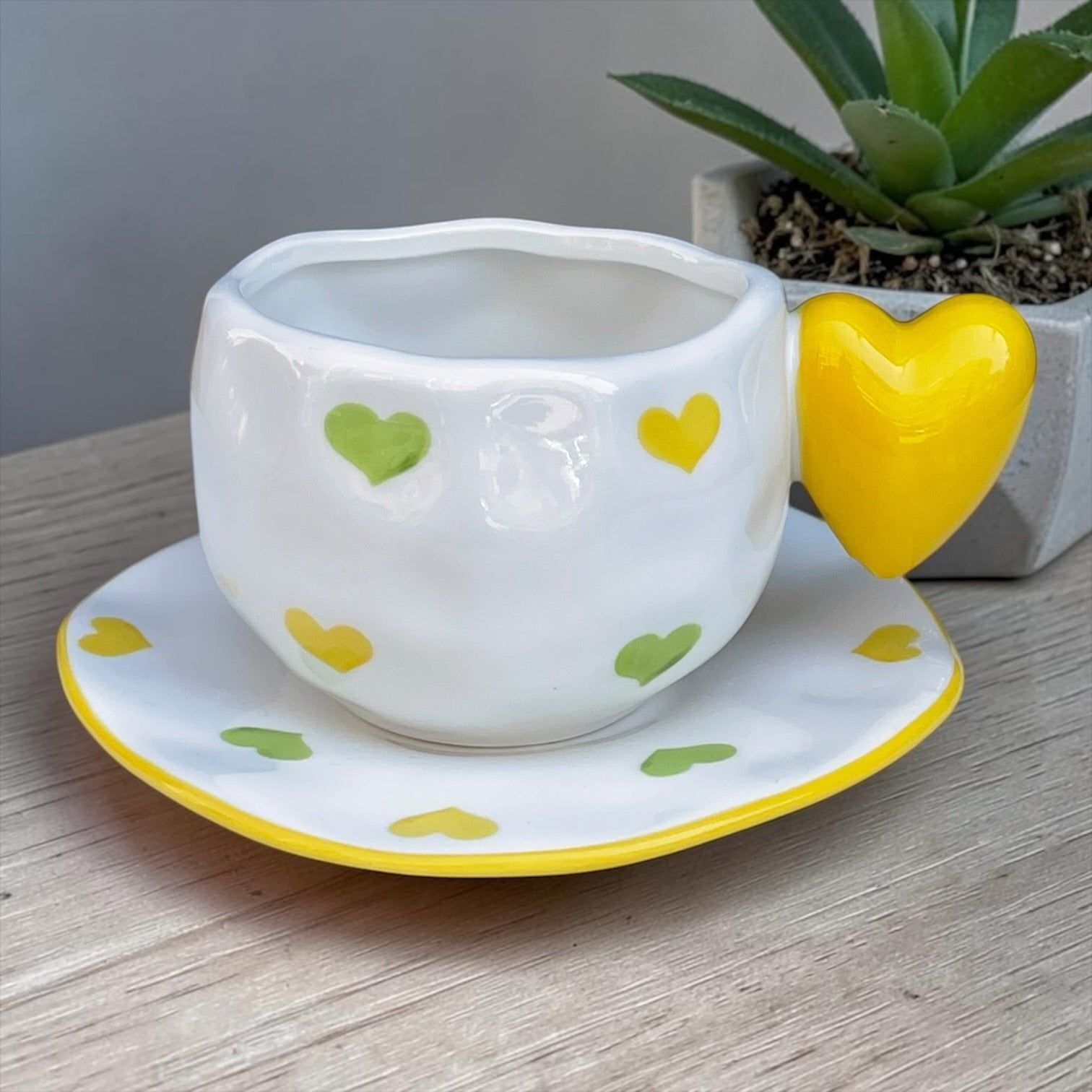 Ceramic mug with heart shaped handle