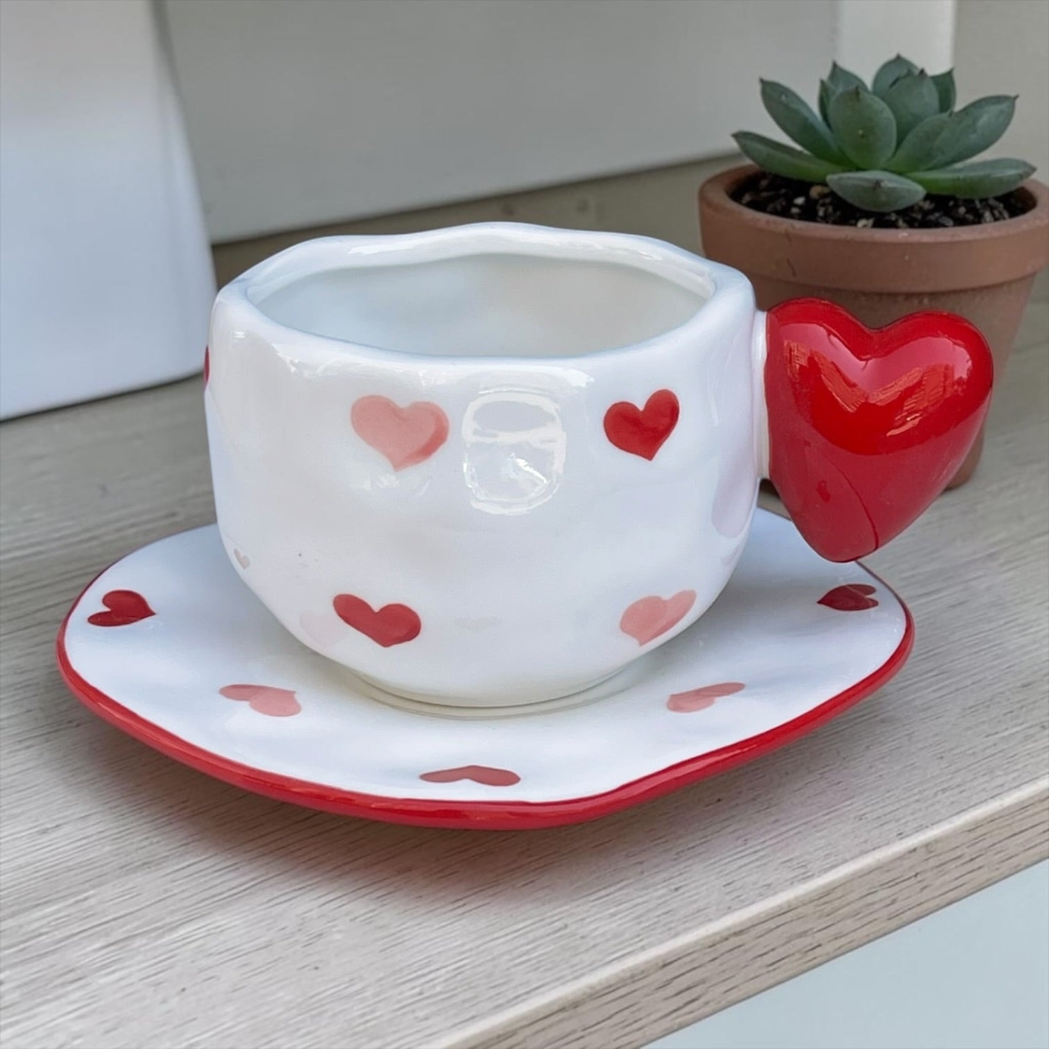 Ceramic mug with heart shaped handle
