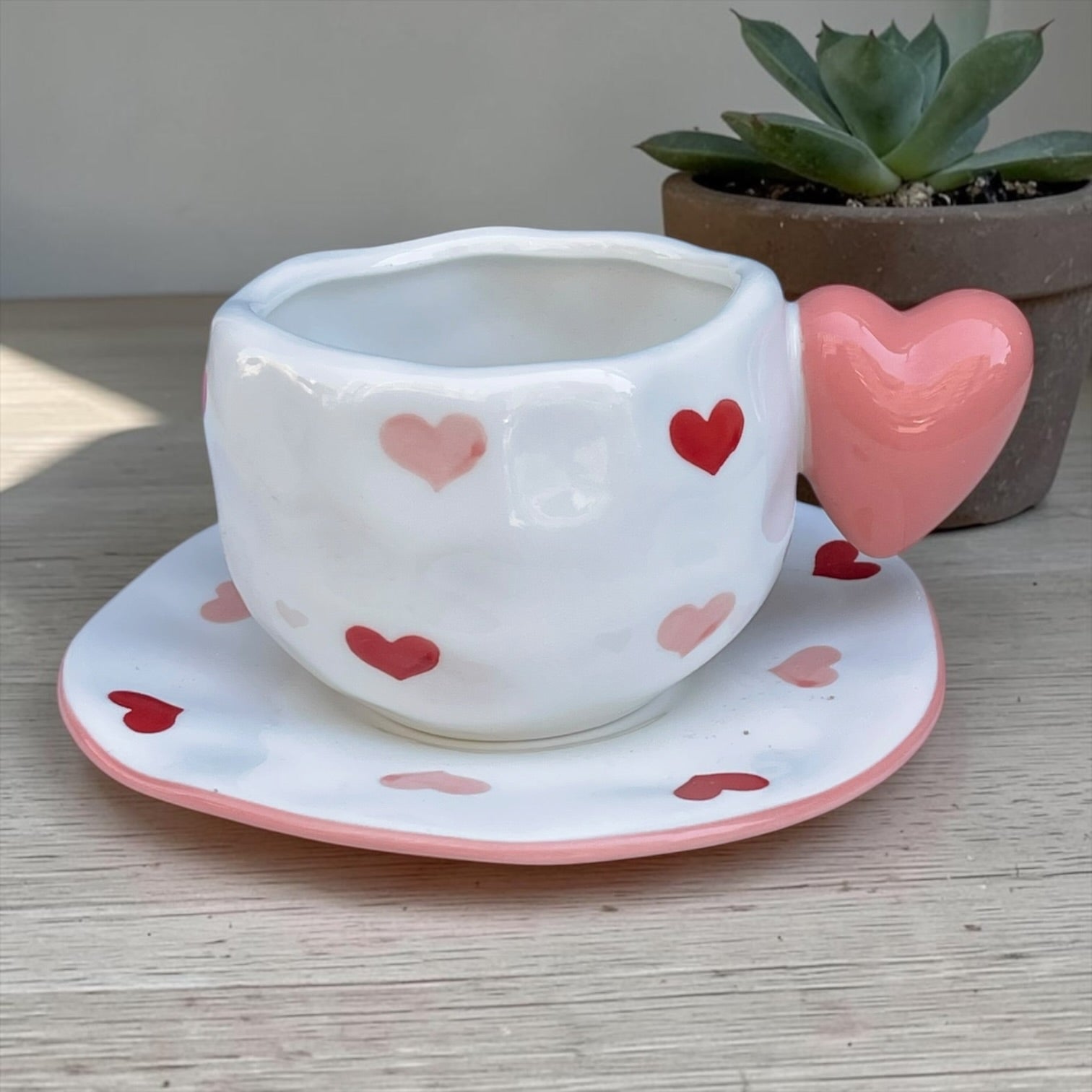 Ceramic mug with heart shaped handle