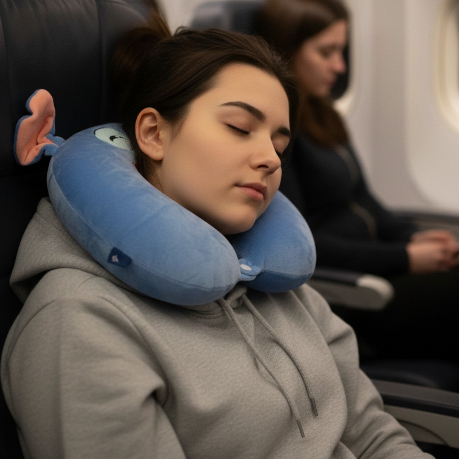 Tagerelsa3ada blue plush character neck pillow with orange ears and a wide smile, perfect for travel comfort.