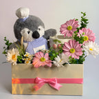Tagerelsa3ada Chef Penguin Flower Arrangement with pink and white daisies in a cream box with pink ribbon.