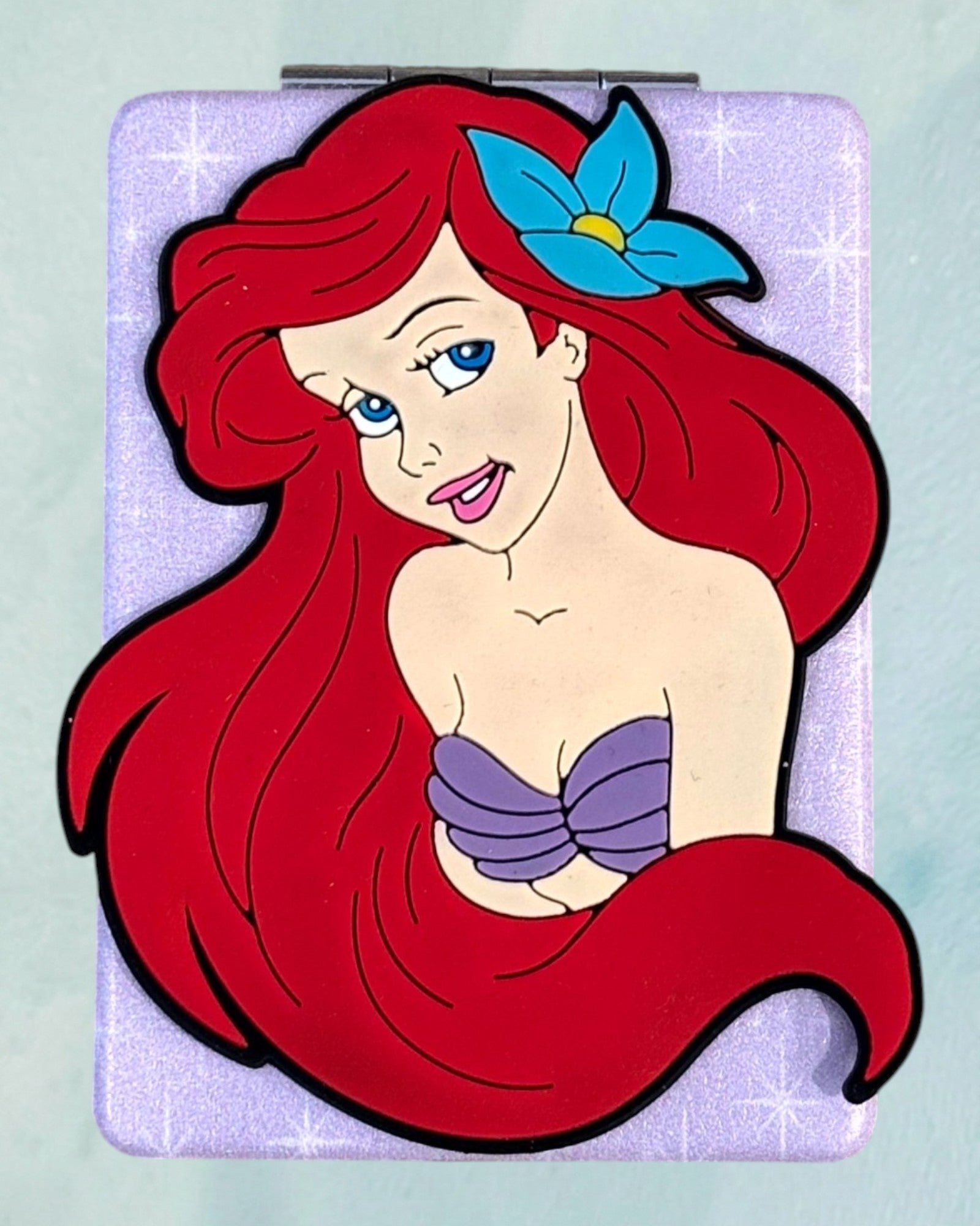 Tagerelsa3ada Disney Ariel compact mirror with purple glitter case and character decal.