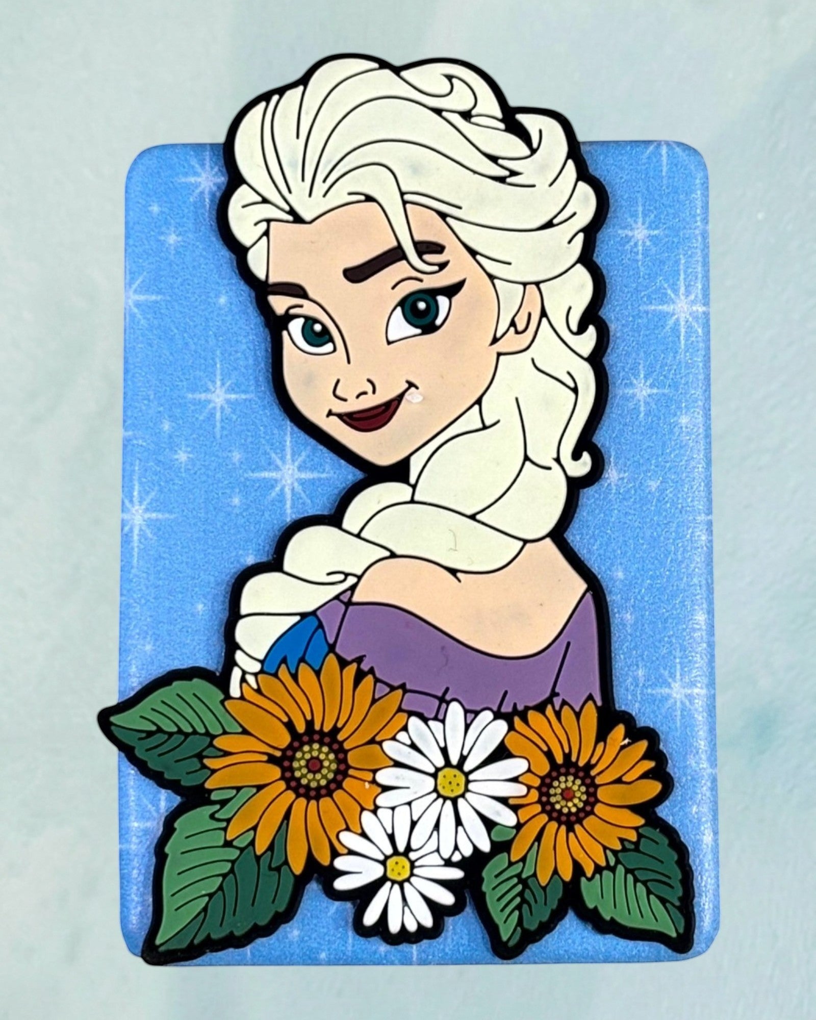 Tagerelsa3ada Disney Elsa from Frozen with sunflowers and daisies on a blue sparkling background.