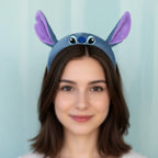 Tagerelsa3ada Disney Stitch plush headband with large purple-lined ears and embroidered facial features.