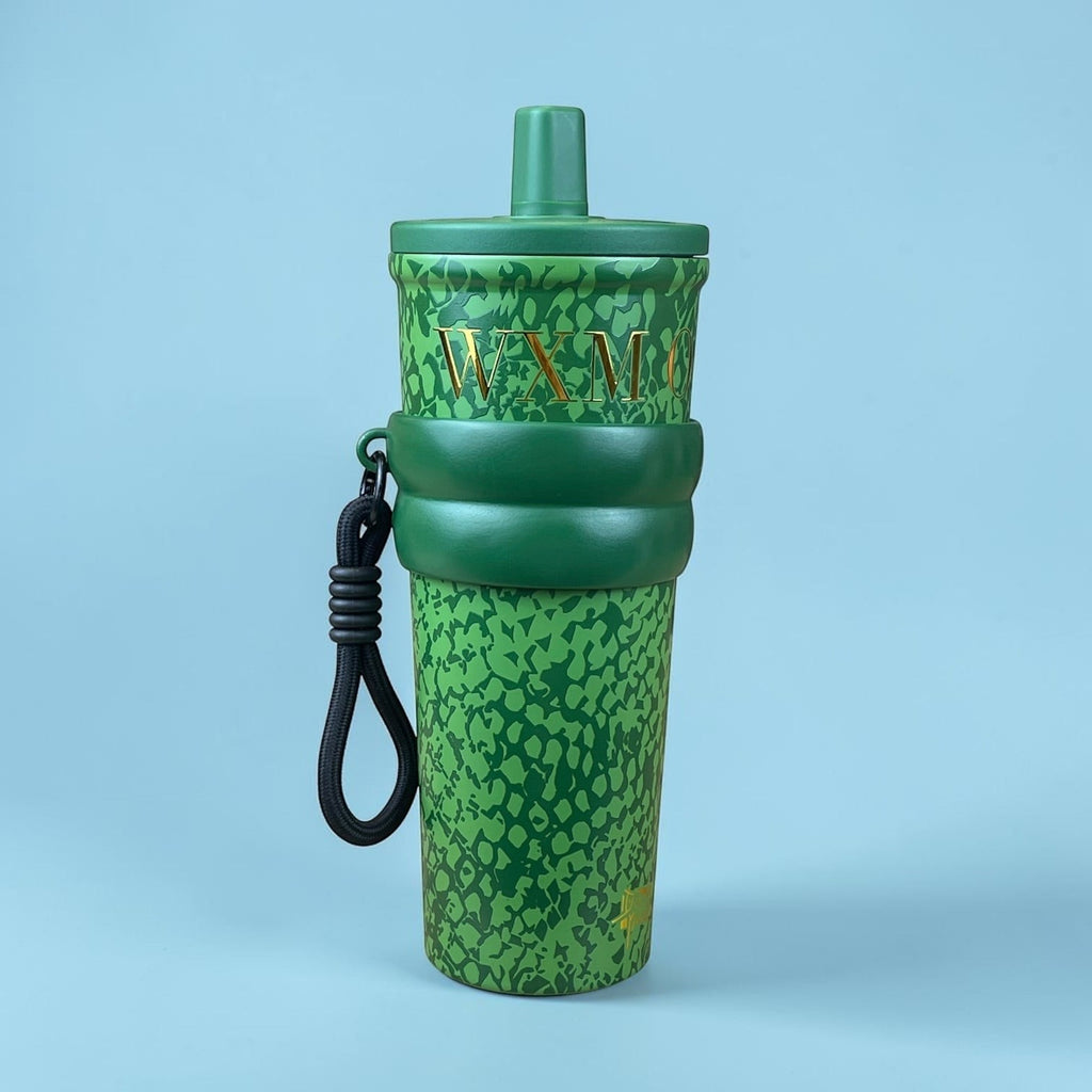 Tagerelsa3ada green snakeskin tumbler with gold lettering and black strap. Durable design with secure lid.
