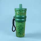 Tagerelsa3ada green snakeskin tumbler with gold lettering and black strap. Durable design with secure lid.