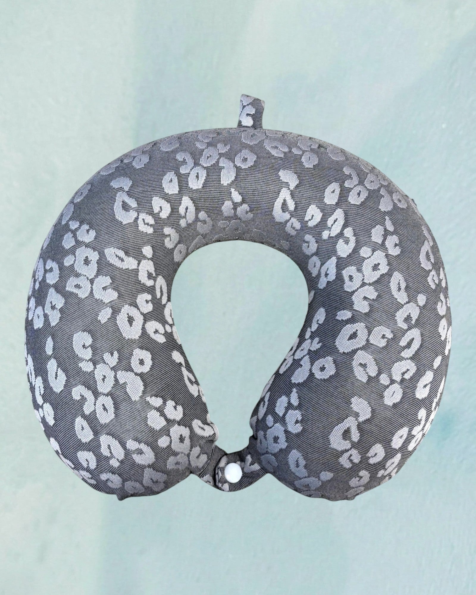 Tagerelsa3ada grey leopard print neck pillow with snap closure for travel comfort.