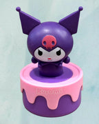 Tagerelsa3ada purple Kuromi figurine on a pink and purple cake-shaped base.