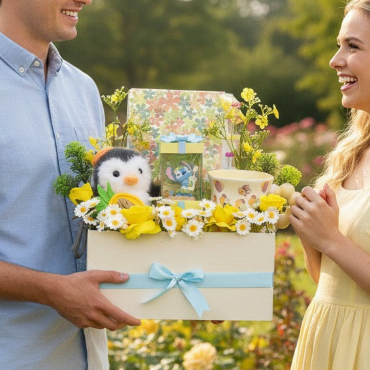 Tagerelsa3ada cream gift box with penguin plush, Stitch figurine, yellow roses, daisies, and mug.