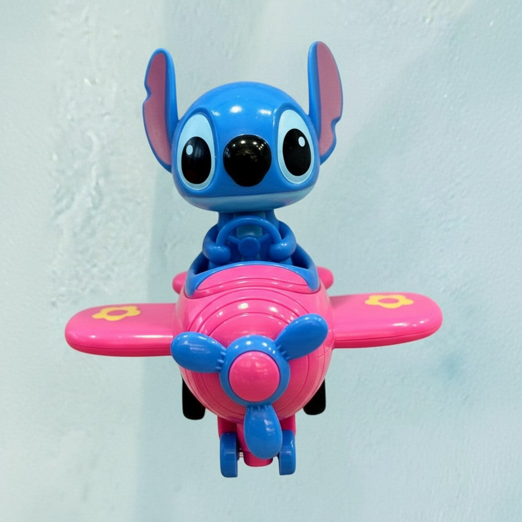 Tagerelsa3ada pink character in blue airplane toy with yellow accents on wings. Plastic construction, ideal for imaginative play.
