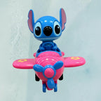 Tagerelsa3ada pink character in blue airplane toy with yellow accents on wings. Plastic construction, ideal for imaginative play.