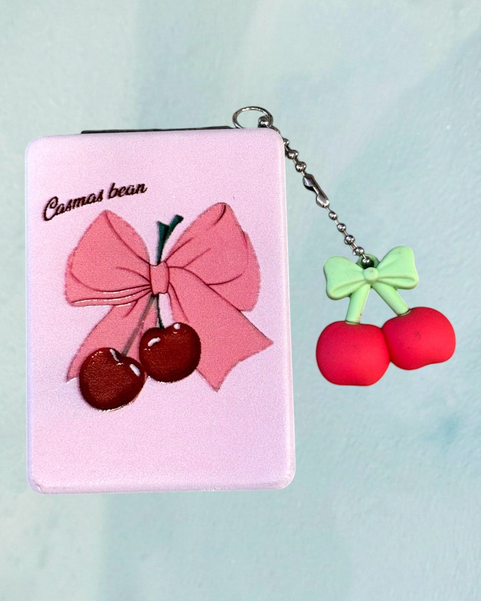 Tagerelsa3ada pink compact mirror with a pink bow and cherry design, featuring a cherry charm.