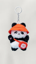 Tagerelsa3ada plush panda keychain with orange hat and red apple bag accessory.