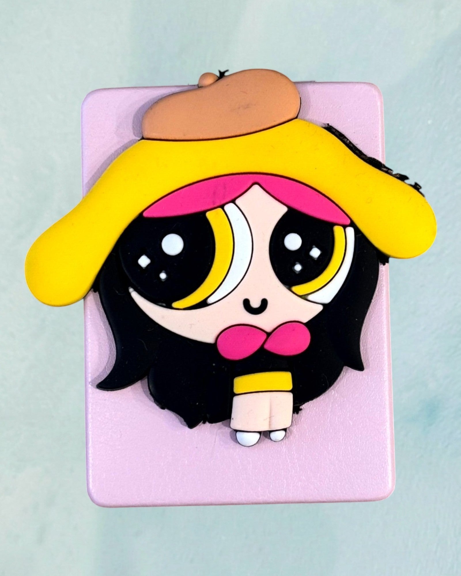 Tagerelsa3ada pink compact mirror with a Powerpuff Girl character design, featuring yellow hair and beret.